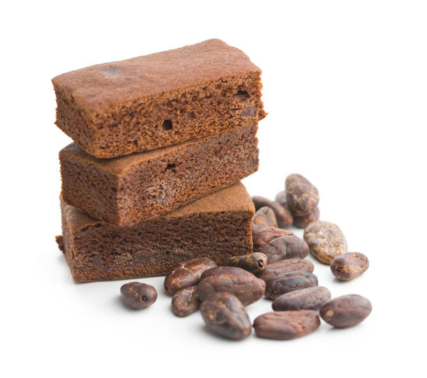Sweet chocolate brownies and cocoa beans isolated on white background.