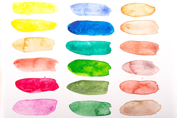 Coloured yellow red green blue watercolor splashes on white paper