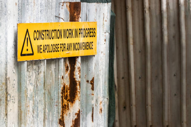 istock A construction work in progress sign board over a corrugated wall panel, outdoors. 1138868537
