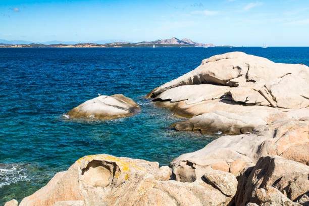 Sardinia Picturesque Coastal View: Rocky Outcrop and Distant Islands of La Maddalena & Isola Caprera in Summer. - Baia Sardinia, Gallura, Sardinia, Italy. - fotografia de stock