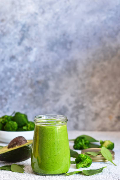 istock Green smoothie with spinach, avocado and broccoli on a concrete background. 1138870470