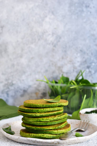 istock Green pancakes with spinach on a light concrete background. Classic breakfast. 1138870496