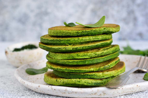 istock Green pancakes with spinach on a light concrete background. Classic breakfast. 1138870538