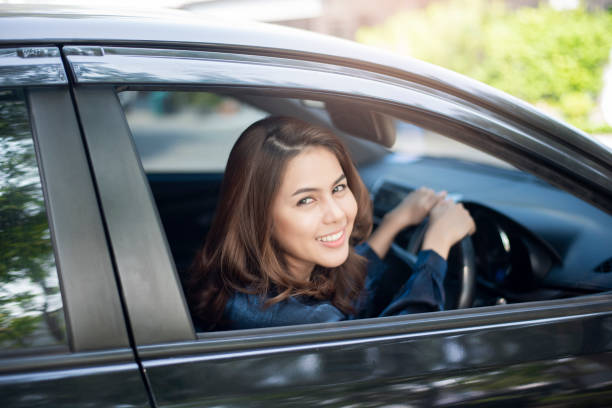 istock Beautiful woman is driving her car 1138872940