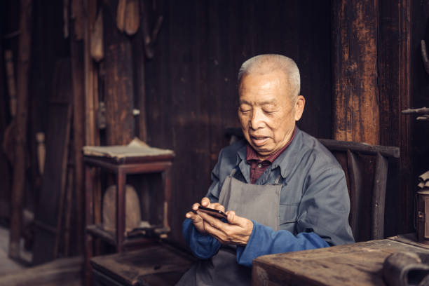 istock Chinese senior man using mobile phone 1138873623