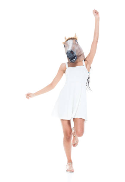 istock Cute female wearing a horse head 1138873626