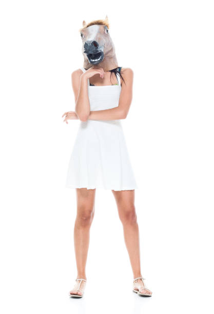 istock Cute female wearing a horse head 1138873635