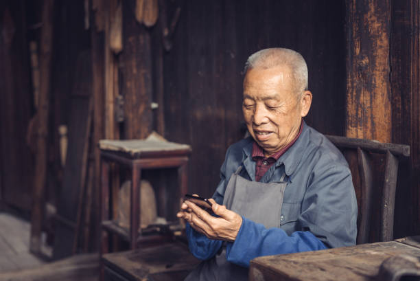 istock Chinese senior man using mobile phone 1138873639