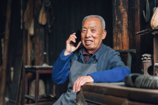 istock Chinese senior man using mobile phone 1138873685