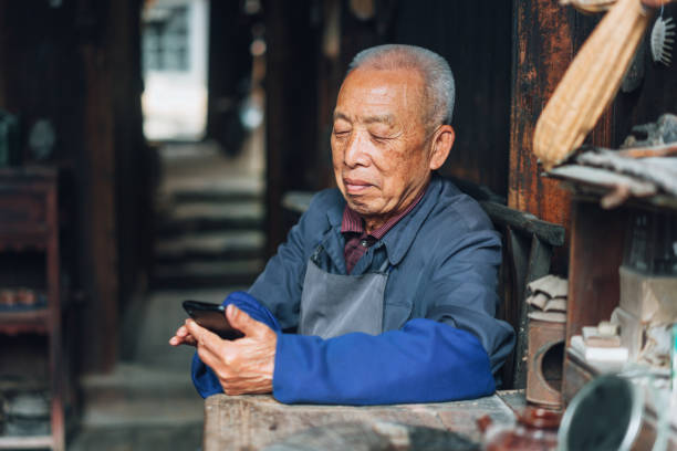 istock Chinese senior man using mobile phone 1138873705
