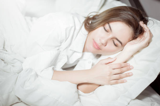istock Beautiful woman sleeping on bed 1138874847