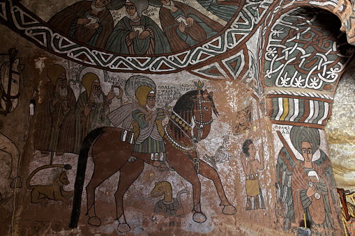 TIGRAY REGION, ETHIOPIA – February 10, 2018: iconographic scenes and wall murals of saints painted in naive african christian style in Abuna Yemata Guh church