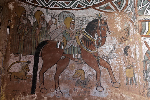 TIGRAY REGION, ETHIOPIA – February 10, 2018: iconographic scenes and wall murals of saints painted in naive african christian style in Abuna Yemata Guh church