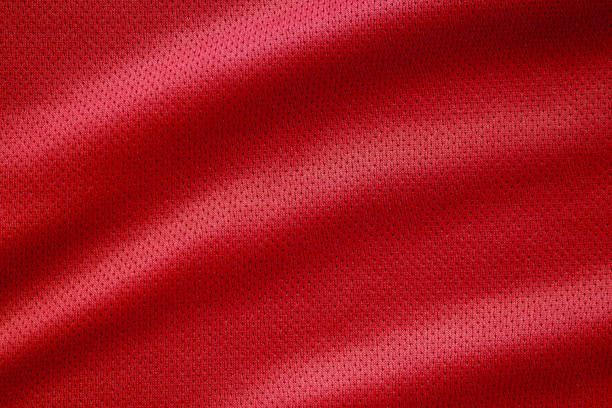 Red fabric sport clothing football jersey with air mesh texture background Red fabric sport clothing football jersey with air mesh texture background jersey fabric photos stock pictures, royalty-free photos & images