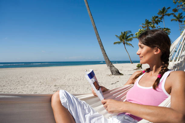 woman reading a magazine on the beach