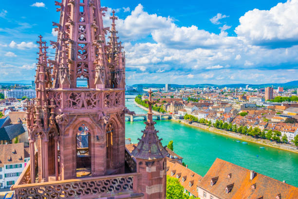 Riverside of Rhine in Basel dominated by majestic building of Munster church, Switzerland Riverside of Rhine in Basel dominated by majestic building of Munster church, Switzerland basel switzerland photos stock pictures, royalty-free photos & images