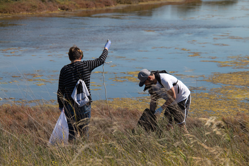 San Fernando, Cadiz, Spain - March 16, 2019: In this image we can see volunteers cleaning the Caño Carrascon, a place where you can observe numerous birds