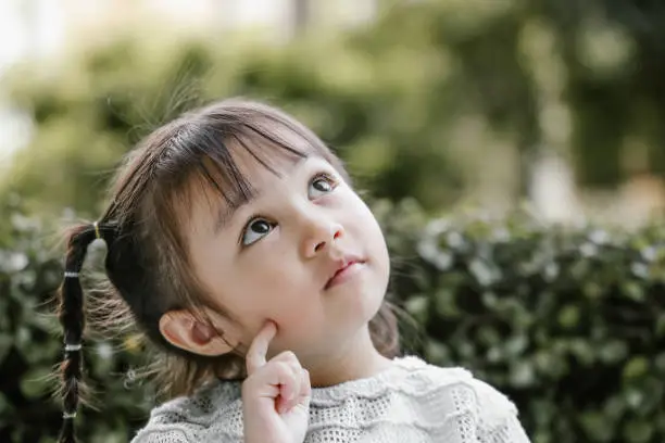 Photo of Beautiful kid playing Thinker with serious