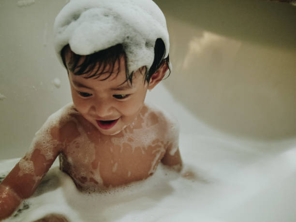 istock Happy baby boy playing with bubbles in bath 1138878061