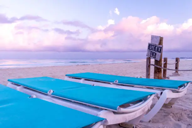 Empty beach chairs on tropical Caribbean island white sand beach
