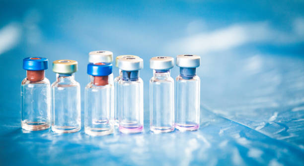 istock Vaccine bottles medical background 1138879720