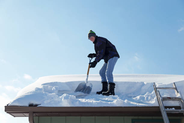 istock Man Shoveling Deep Snow Off a Rooftop 1138880528