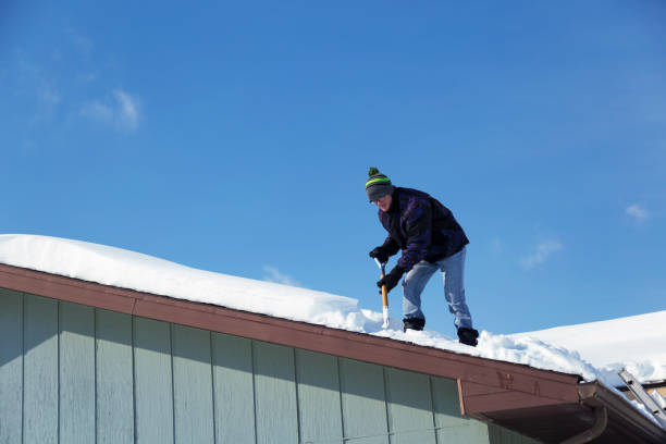 istock Man Shoveling Deep Snow Off a Rooftop 1138880530