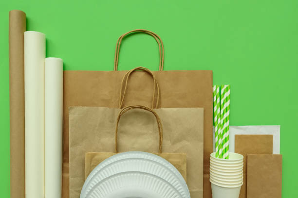istock Plastic packages on green background. Copy space. Top view. Eco and save earth concept. 1138880741