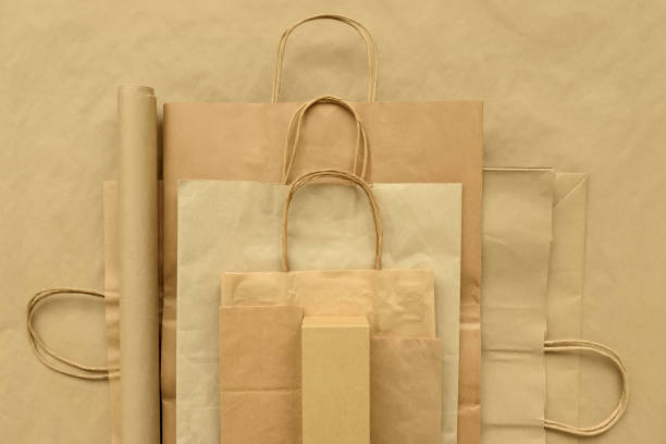 istock Paper packages on brown background. Copy space. Top view. Eco and save earth concept. 1138880791