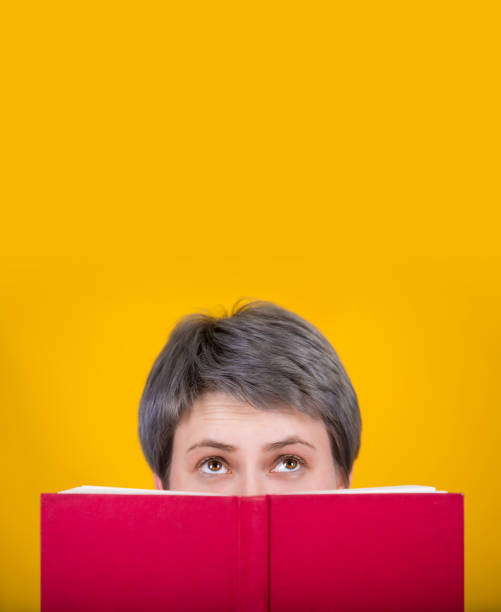 istock woman hidden behind book 1138884114