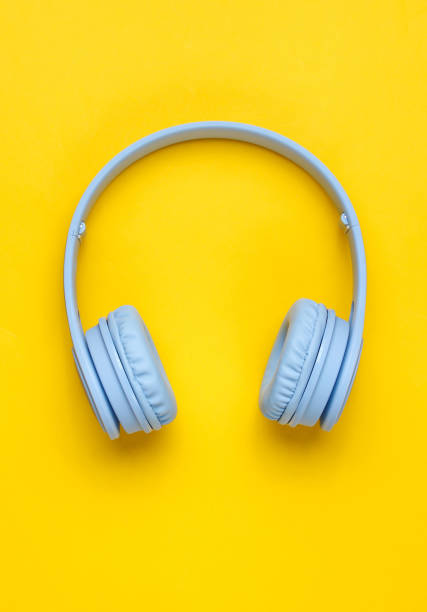 istock Modern Wireless Over-Ear Blue Headphones on yellow background. Minimalism. Top view 1138885446