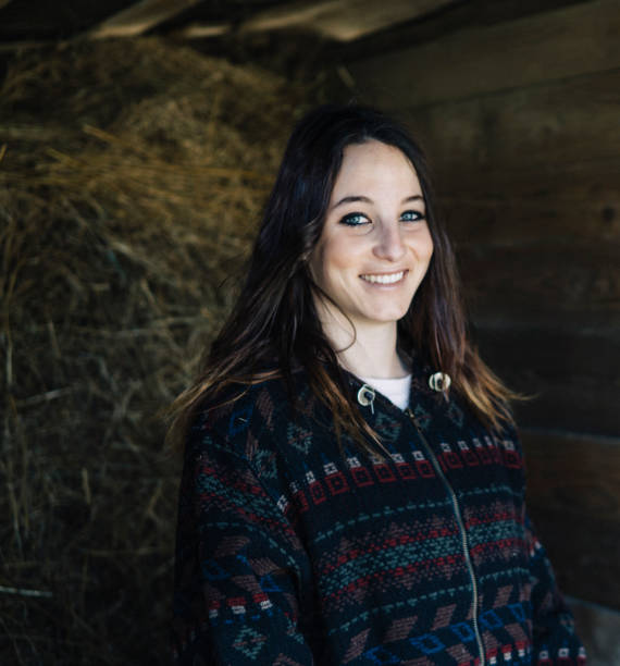 istock Young beautiful woman farmer in a stable 1138885559