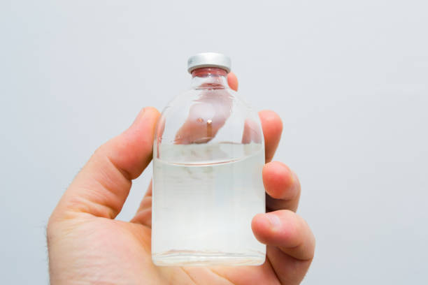 istock glass bottle with transparent drug solution in a man's hand 1138886918
