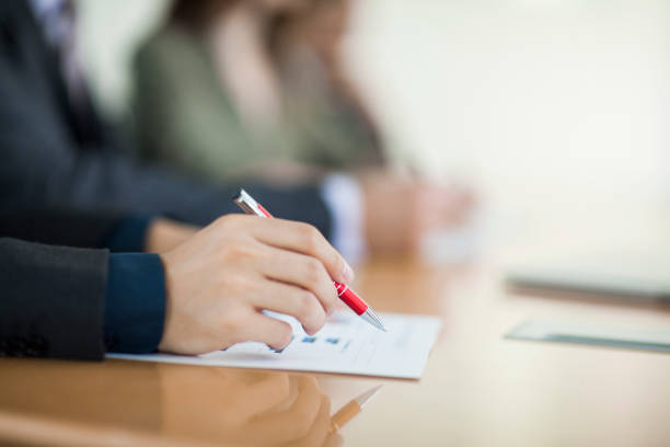 istock Hand pointing with pen on table in meeting 1138887361