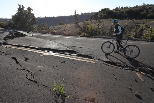 The road is cracked and broken from an earthquake, Hawaii Volcanoes National Park