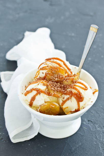 istock vanilla ice cream with bananas and caramel in a bowl. 1138888395