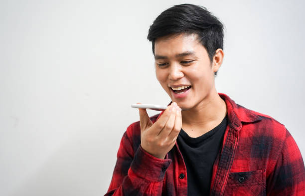 istock close up young asian man holding smartphone and using voice control for search data information  or access application , people  technology concept 1138890667