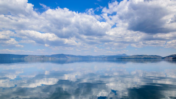 istock Pristine Waters and Dramatic Cloudy Sky Reflected on Placid Lake Ilopango, El Salvador 1138890814