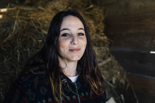 istock Young beautiful woman farmer in a stable 1138890826