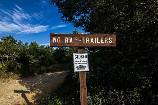 NO RV TRAILERS ALLOWED SIGN AT THE YEARLING TRAIL warns visitors not to enter with RV or Trailers on this area.  Shot on a hot 2018 summer day near the Ocala National Forest on the town of  Fort McCoy, FL