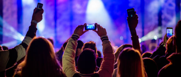 istock Crowd filming a concert with their smartphones 1138892306