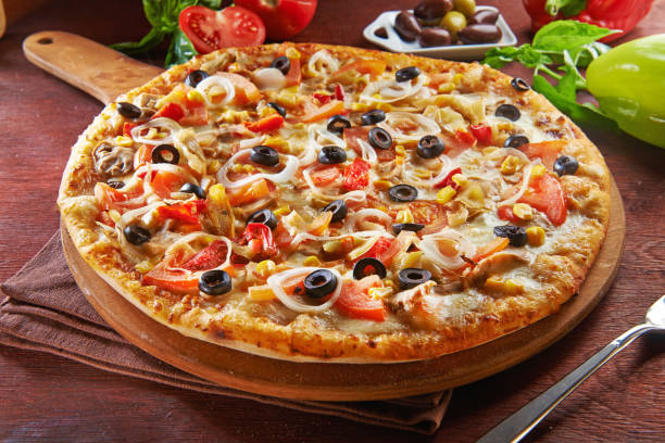 istock whole italian pizza on wooden table with ingredients 1138894702