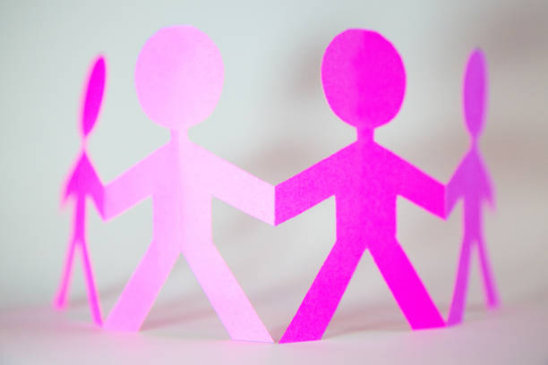 Paper cut outs (made by me) depicting a family group held in the palms of youthful hands - could be used to depict  parenting/social/family/childhood issues