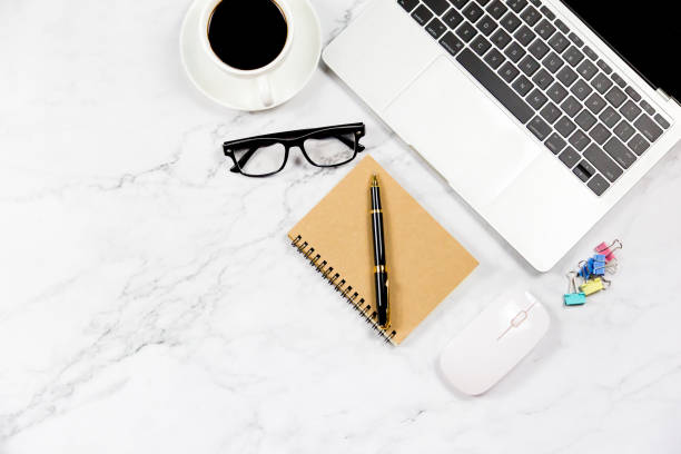 istock Workspace in office , Marble White desk with blank notebook and other office supplies,Top view with copy space. 1138895349