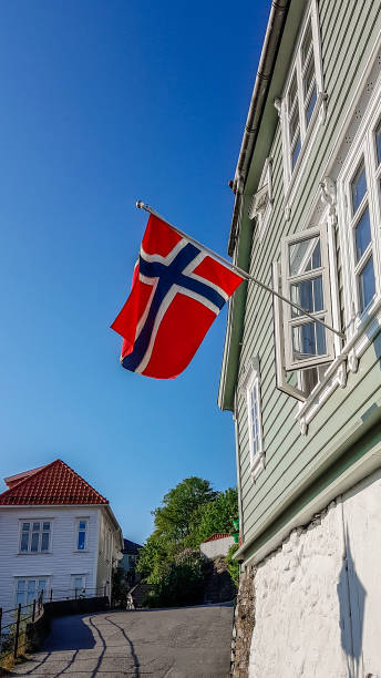 istock Norway - Little street with a Norwegian flag 1138896268