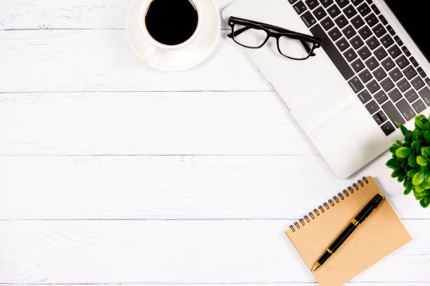 istock Workspace in office , Wooden White desk with blank notebook and other office supplies,Top view with copy space. 1138897113
