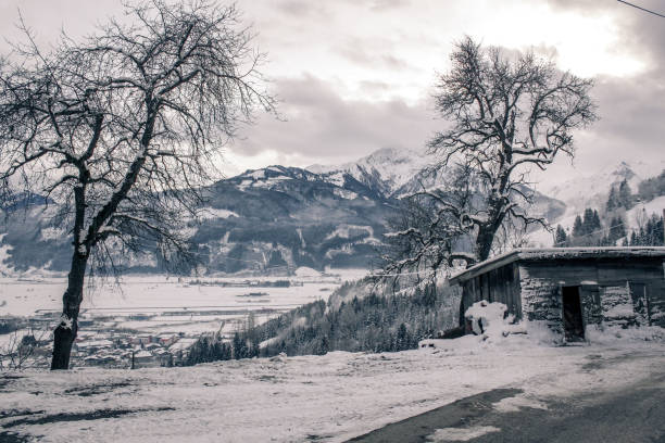 White winter photograph of a valley in the mountains with a river, road and several villages. Taken from a villa in the early morning, before a day-long snowboard ride. Zillertal, Tyrol, Austria.