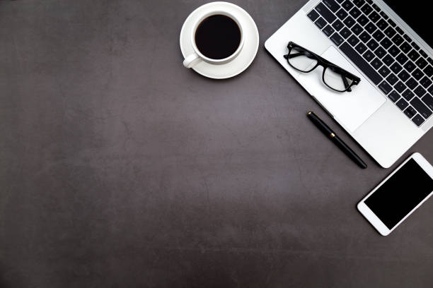 istock Workspace in office ,Black desk with blank notebook and other office supplies,Top view with copy space. 1138898165