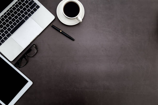 istock Workspace in office ,Black desk with blank notebook and other office supplies,Top view with copy space. 1138898609