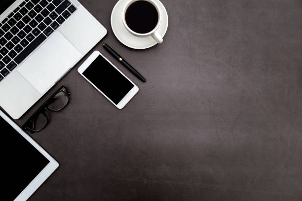 istock Workspace in office ,Black desk with blank notebook and other office supplies,Top view with copy space. 1138899291